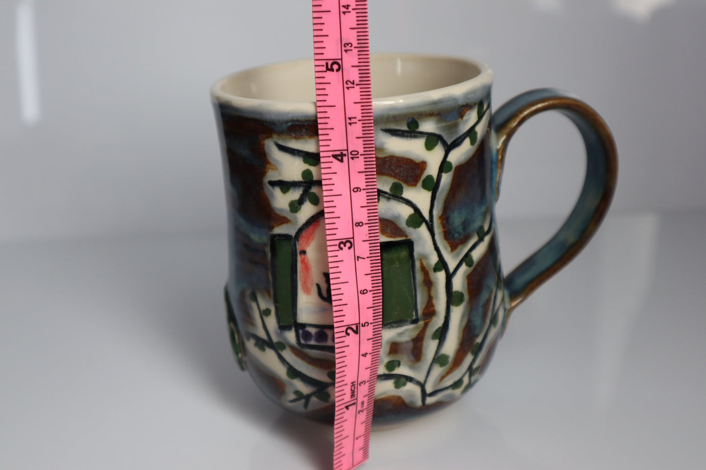 Mug with a oink tape measure to show scale