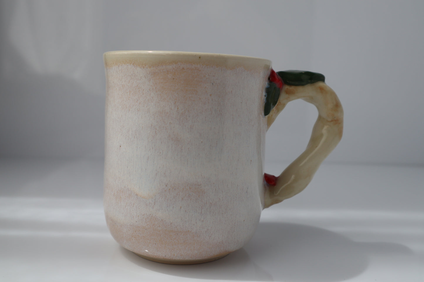Ceramic mug with a branch handle on a white background