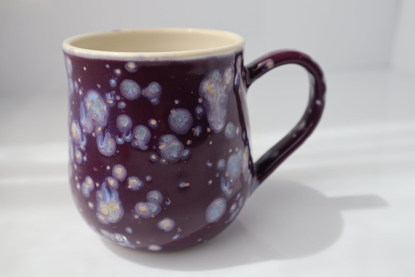 Mug with purple and white speckled design on a white background