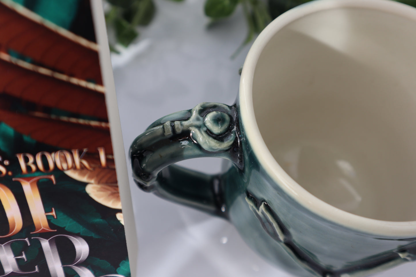 Green mug with a key on the handle on a white surface