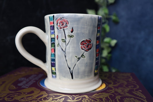 Ceramic mug with floral design on a dark background