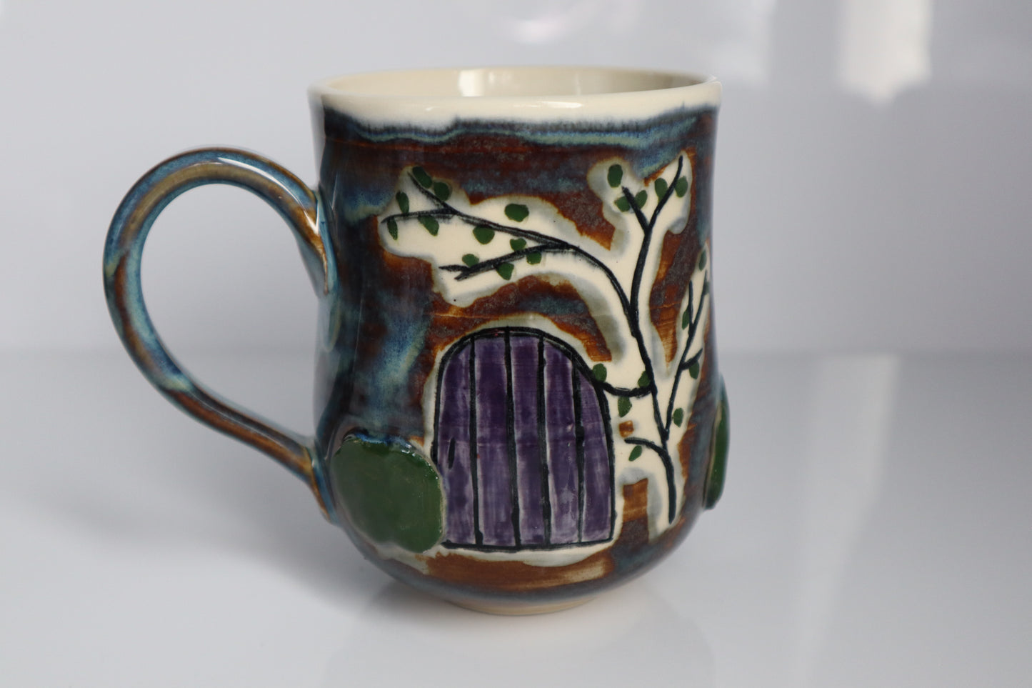 Mug with a purple door on the front if it with a white background.