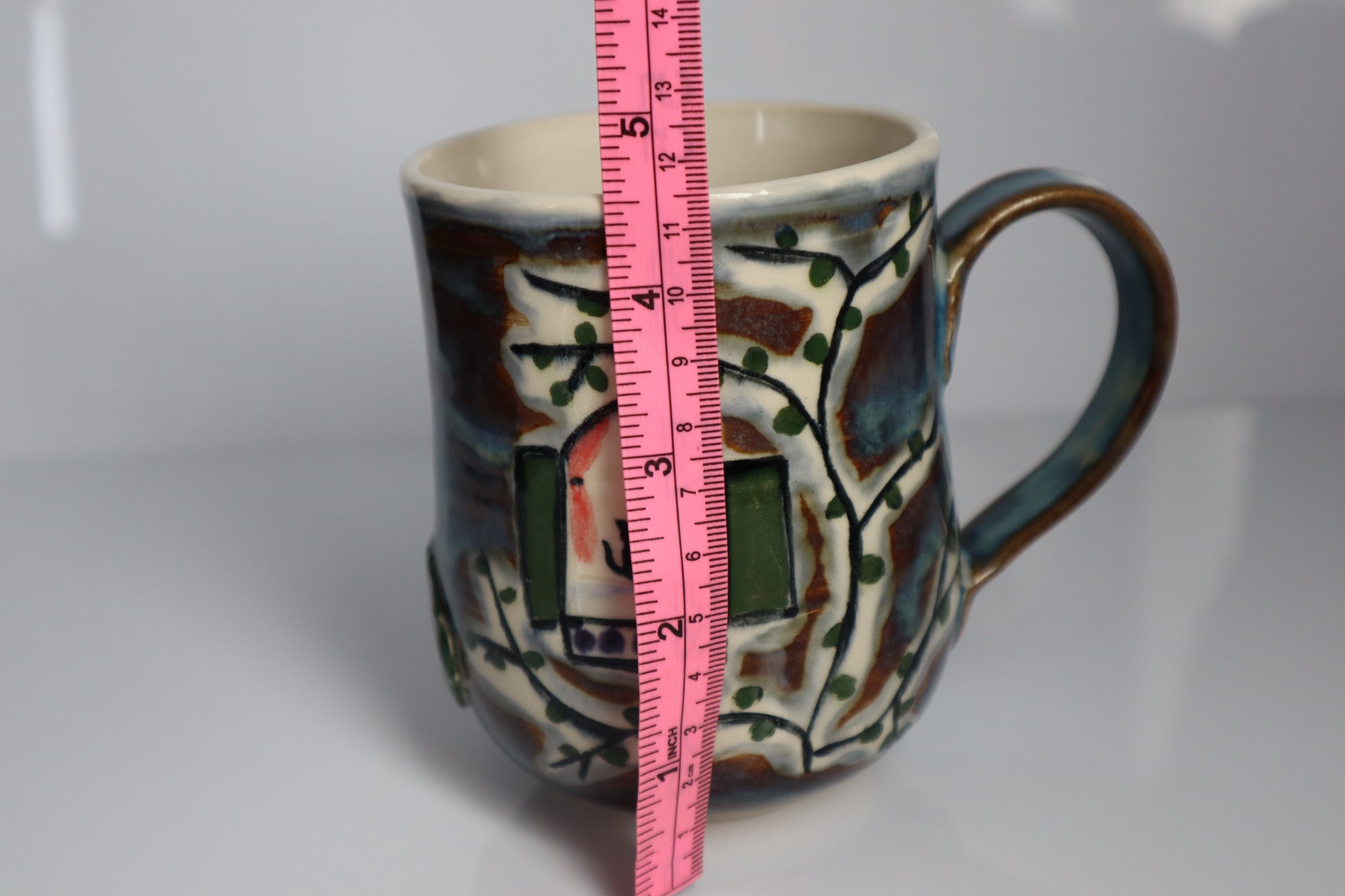 Mug with a oink tape measure to show scale