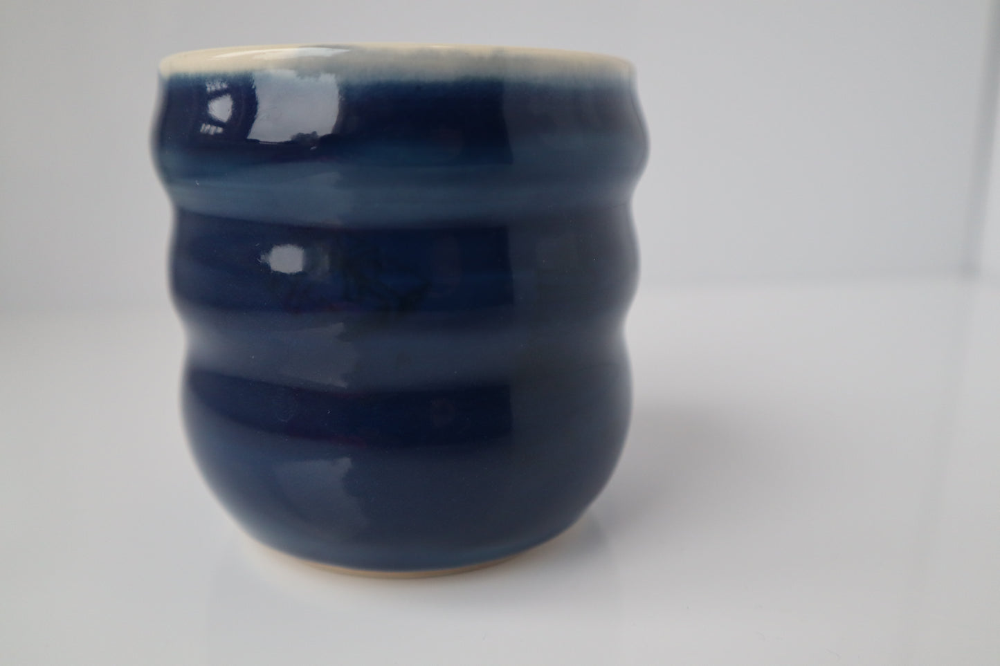 blue ceramic cup on white background